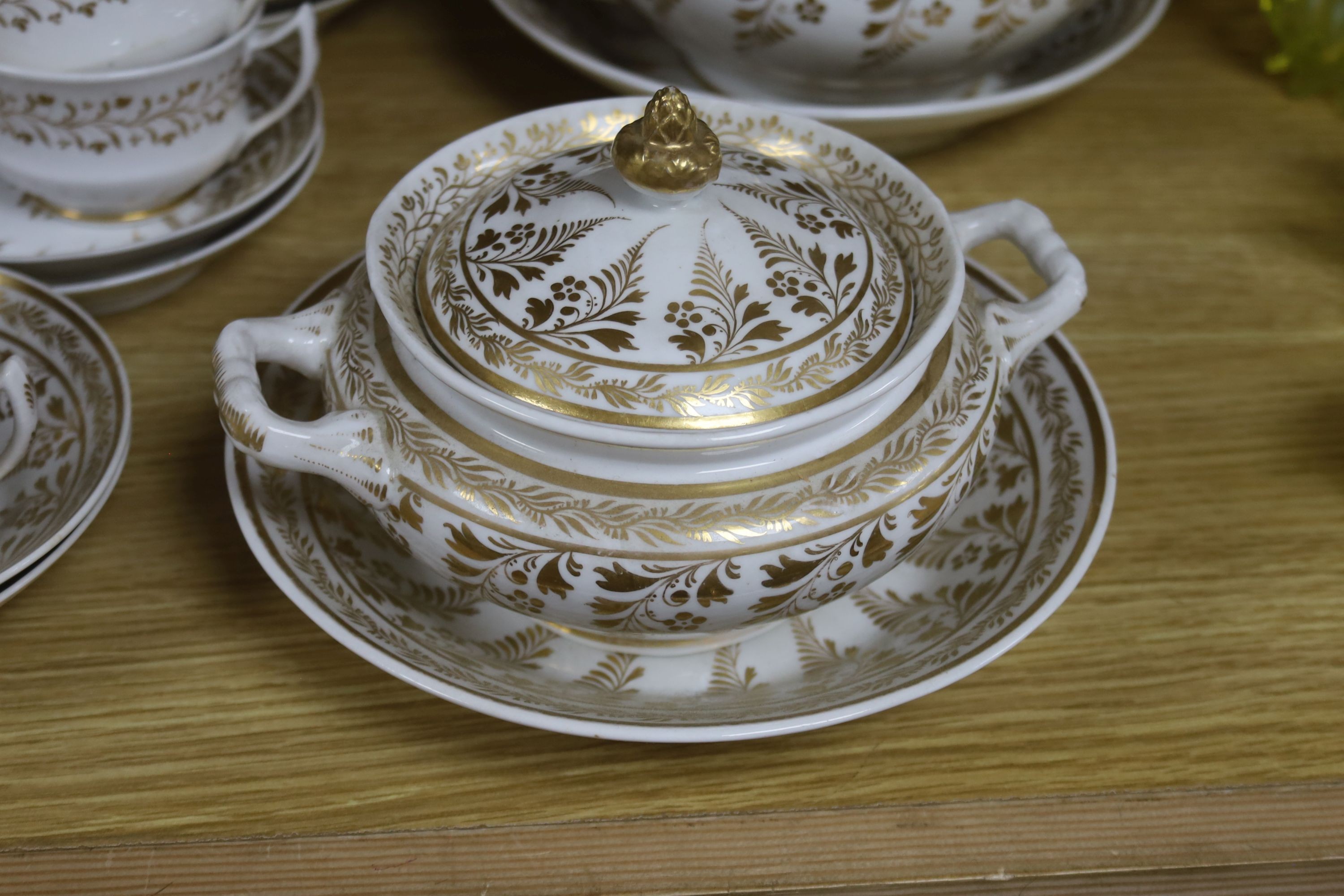 An early 19th century English porcelain gilt decorated part tea and coffee set